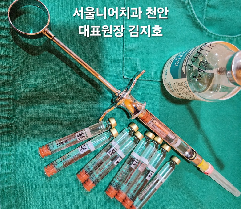녹색 배경 위에 놓인 주사기, 약병, 여러 개의 바늘이 있는 의료 기구